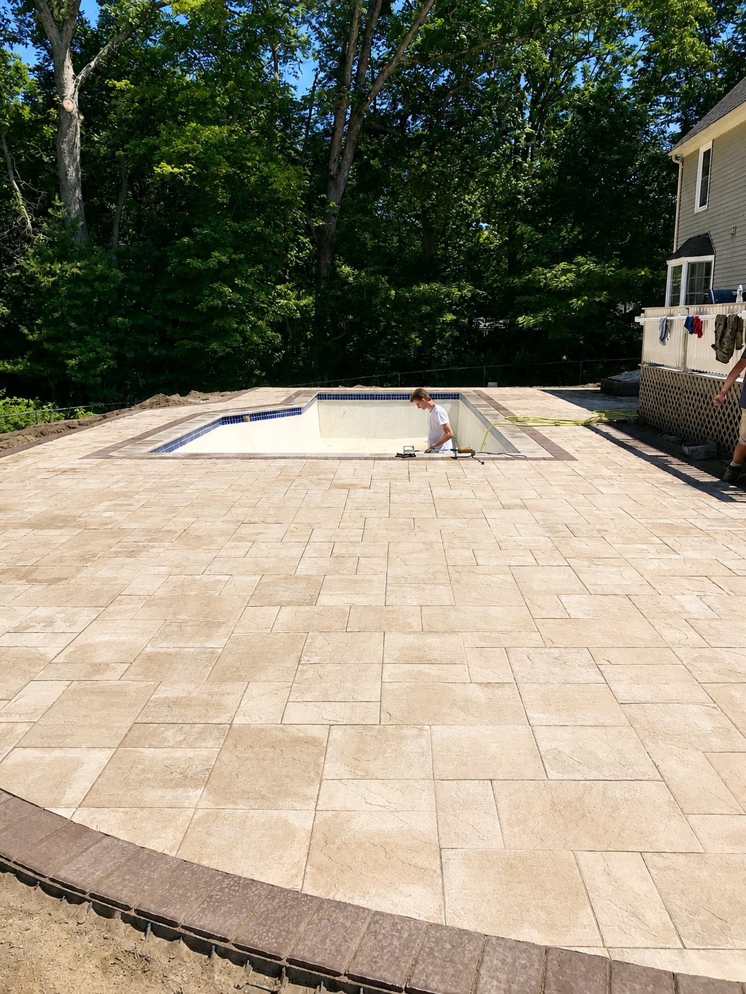Eric and the Precision Excavation crew installing a paver pool deck in Massachusetts