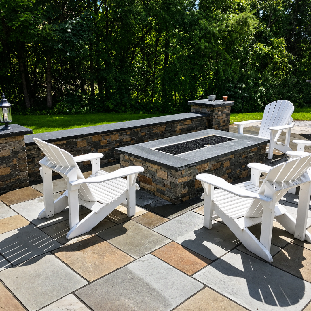 Patio seating area with custom stone fire feature and white Adirondack chairs
